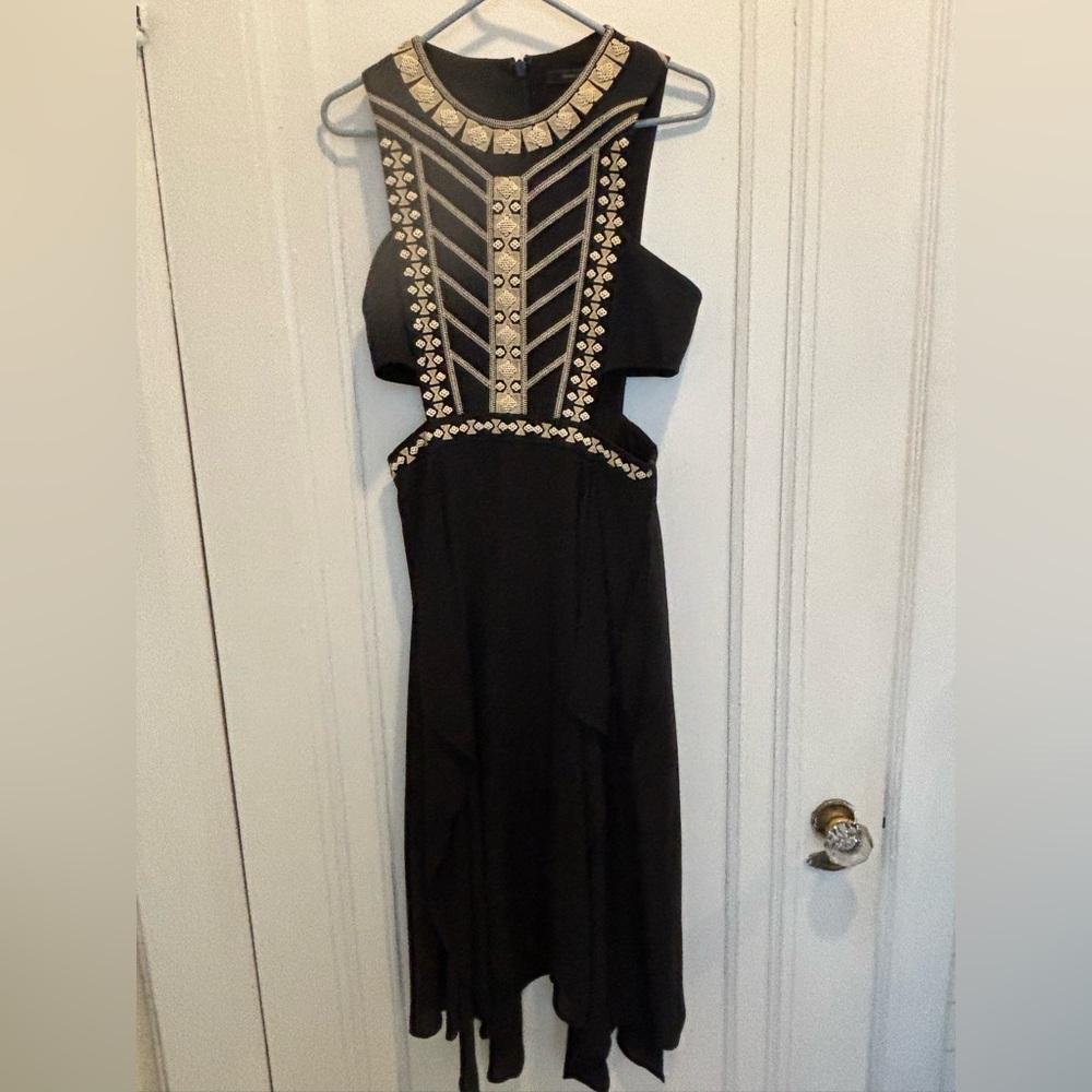 BCBC/MaxAzria stunning dress on with a teared chiffon bottom and 2 side cut outs